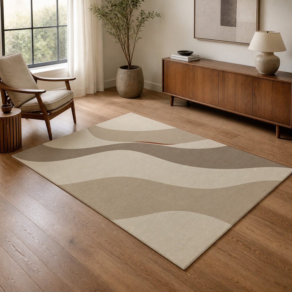 Kartela Flow washable modern wave area rug in Beige, in a living room with an armchair and sideboard