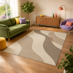 Kartela Flow washable modern wave area rug in Beige, in a sunny living room with a green sofa