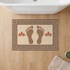 Kartela Footprints washable footprint bath mat in Beige, on a wooden floor in front of a bathtub