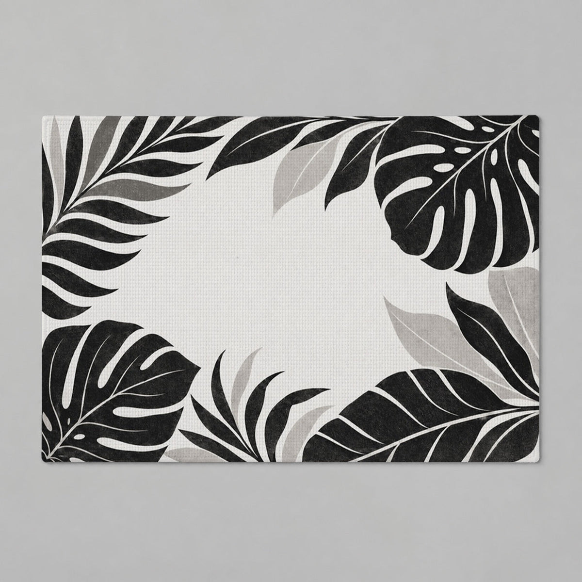 Kartela Monstera Frame washable tropical leaf bath mat in Black & White, flat product view on a gray background