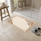 Kartela Diatomite washable stone-look bath mat in Beige, in front of a glass shower with slippers