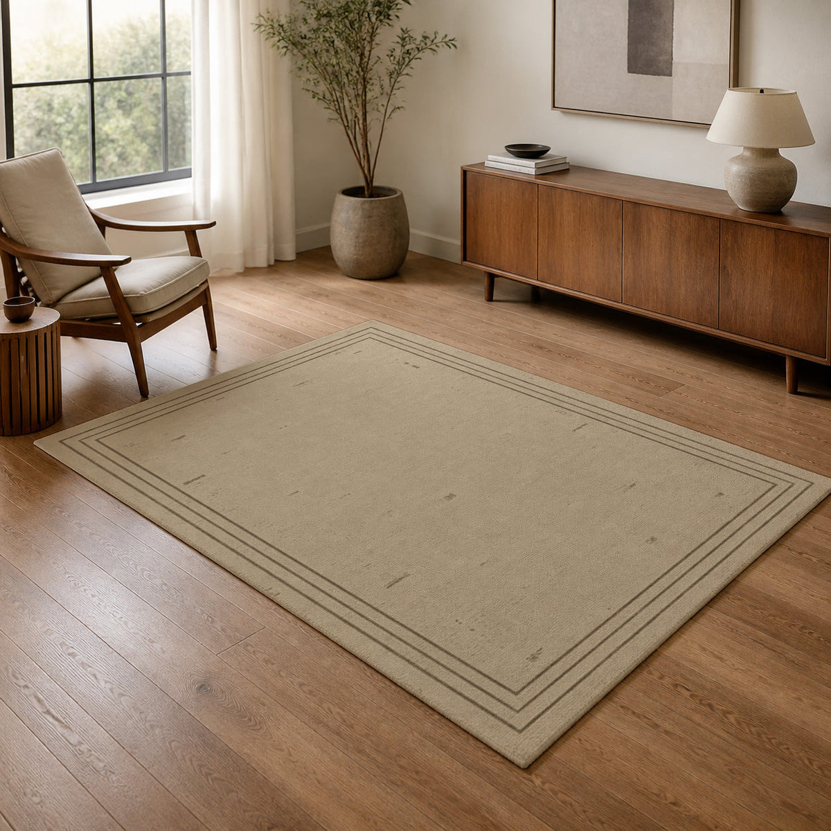 Kartela Weathered Line washable distressed bordered area rug in Beige, in a living room with an armchair and sideboard