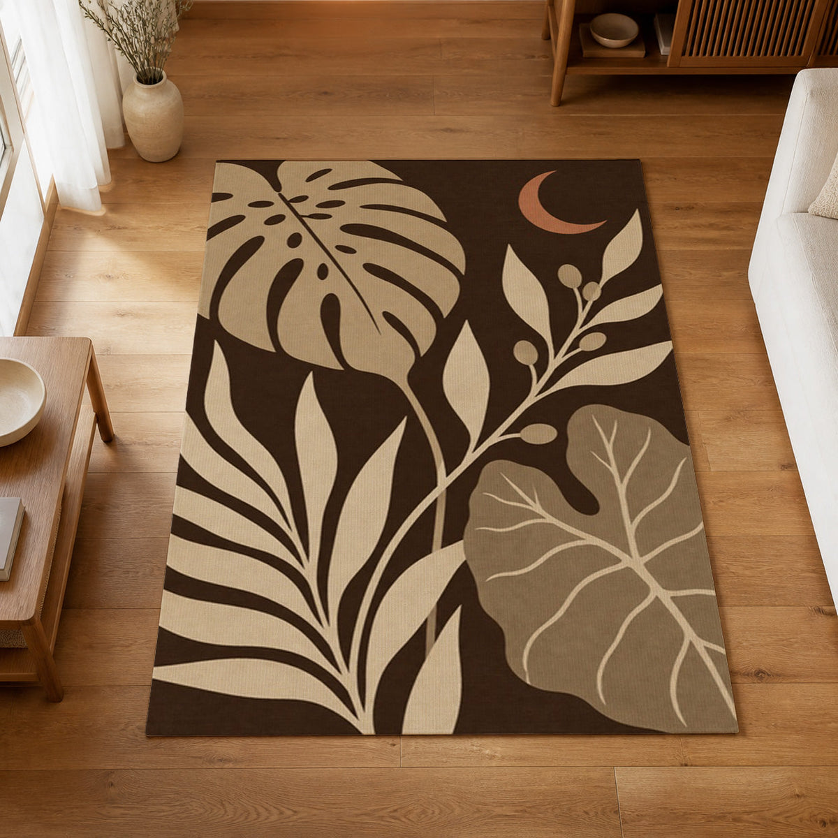 Kartela Night Garden washable tropical leaf area rug in Beige, on a wooden floor in a bright living room