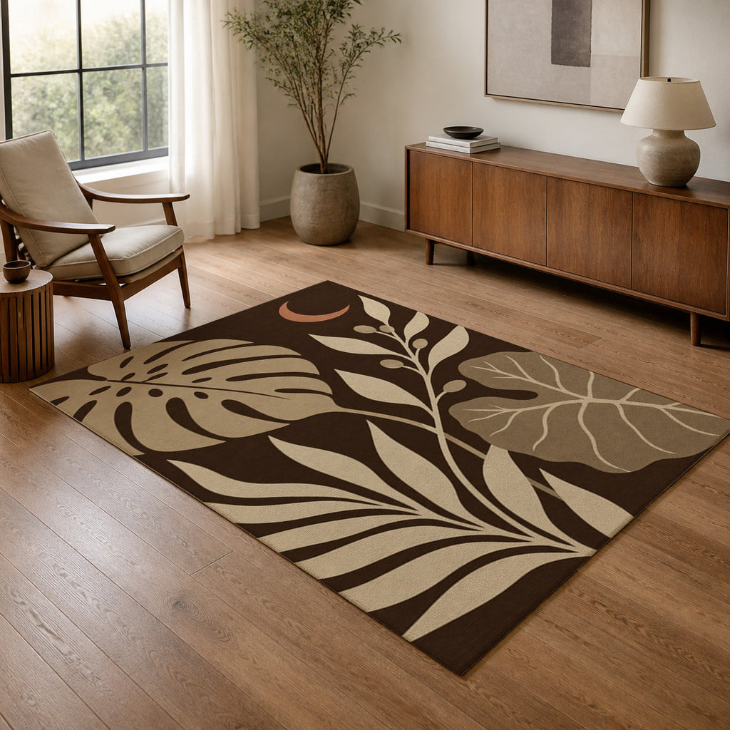 Kartela Night Garden washable tropical leaf area rug in Beige, in a living room with an armchair and sideboard