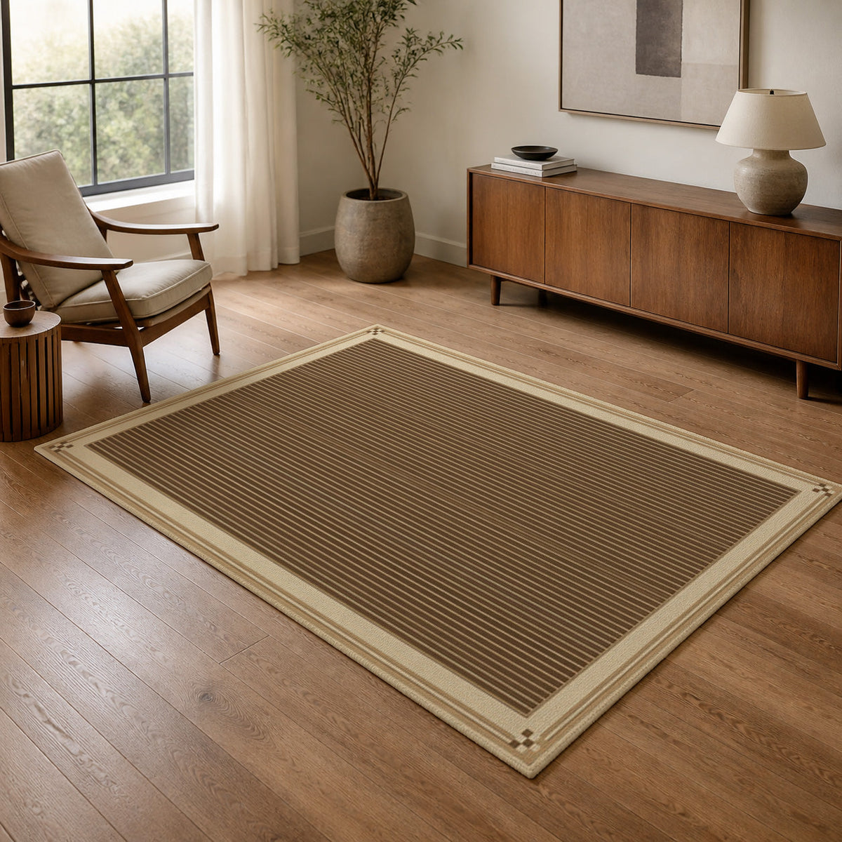 Kartela Fine Stripe washable striped bordered area rug in Beige, in a living room with an armchair and sideboard