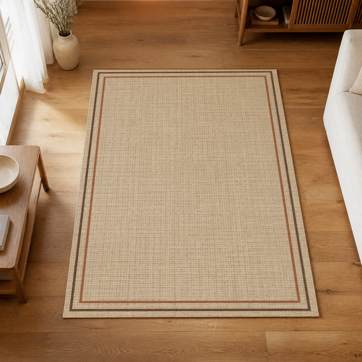 Kartela Double Frame washable jute-look double border area rug in Beige, on a wooden floor in a bright living room