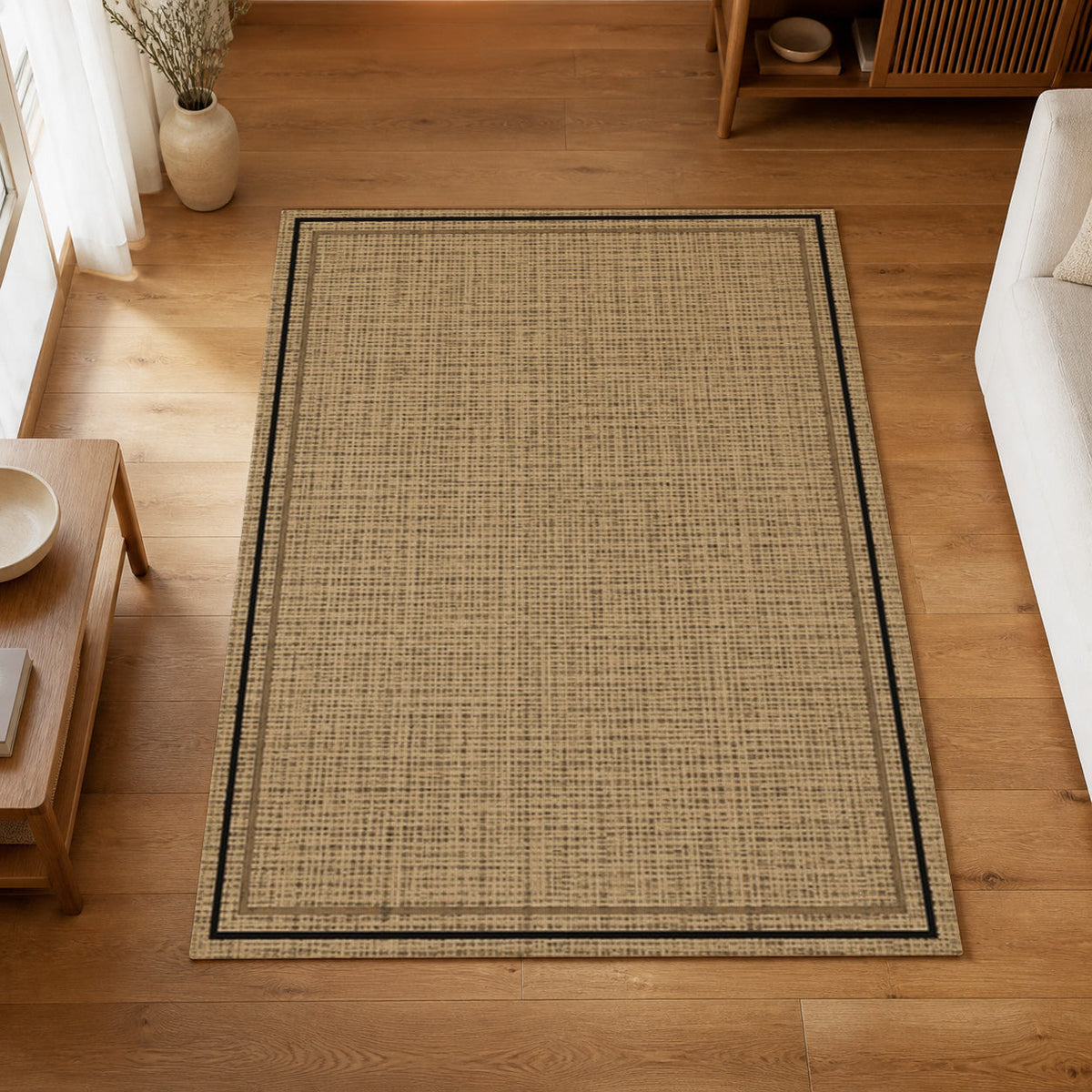 Kartela Double Frame washable jute-look double border area rug in Natural Black, on a wooden floor in a bright living room