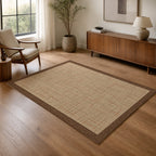 Kartela Jute Frame washable jute-look bordered area rug in Beige, in a living room with an armchair and sideboard