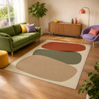 Kartela Cairn washable modern stone area rug in Beige, in a sunny living room with a green sofa