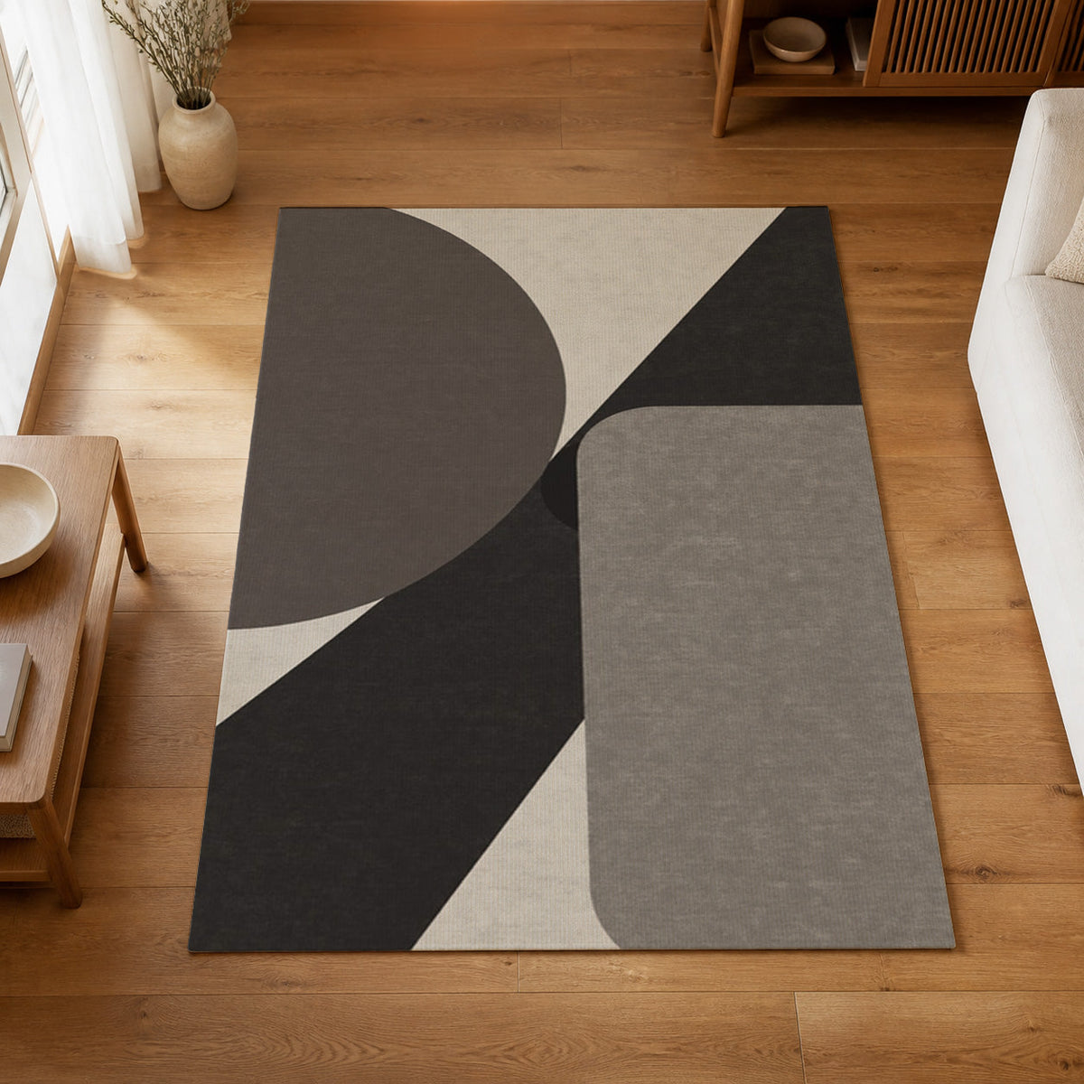 Kartela Intersect washable geometric modern area rug in Charcoal, on a wooden floor in a bright living room