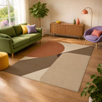 Kartela Intersect washable geometric modern area rug in Beige, in a sunny living room with a green sofa