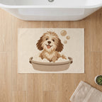 Kartela Bath Pup washable dog bath mat in Beige, on a wooden floor in front of a bathtub