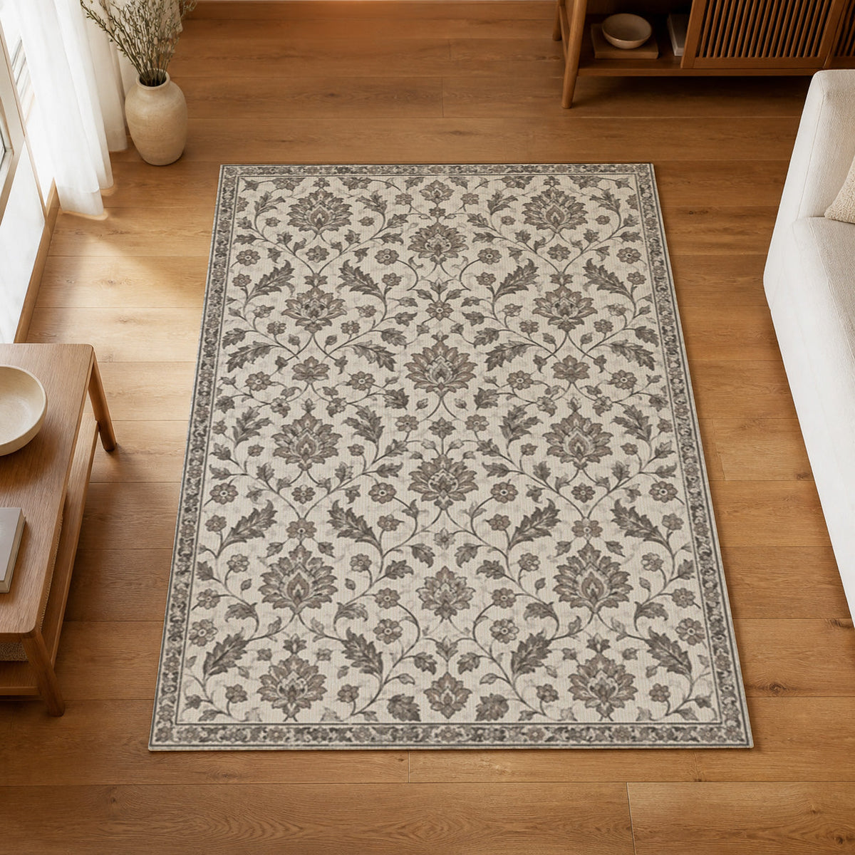 Kartela Persian Field washable vintage Persian style area rug in Light Gray, on a wooden floor in a bright living room