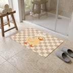 Kartela Duck Check washable checkered duck bath mat in Beige, in front of a glass shower with slippers