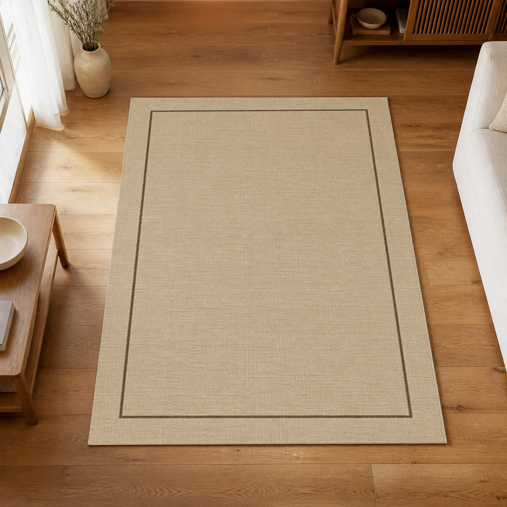 Kartela Sisal Line washable sisal-look minimal area rug in Beige, on a wooden floor in a bright living room