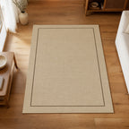 Kartela Sisal Line washable sisal-look minimal area rug in Beige, on a wooden floor in a bright living room