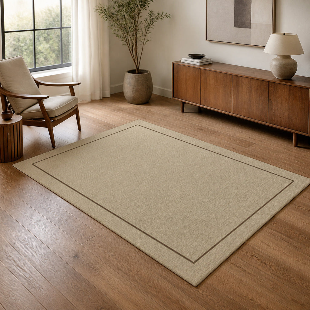 Kartela Sisal Line washable sisal-look minimal area rug in Beige, in a living room with an armchair and sideboard