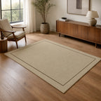 Kartela Sisal Line washable sisal-look minimal area rug in Beige, in a living room with an armchair and sideboard